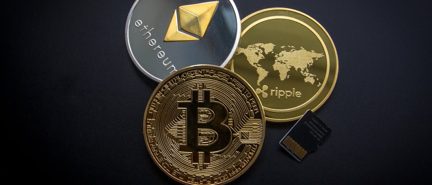 A striking image of Bitcoin, Ethereum, and Ripple coins illustrating modern digital currency.