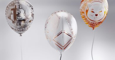 a group of three balloons with a cat design on them