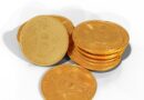a pile of gold bitcoins sitting on top of each other