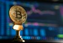 selective focus photo of Bitcoin near monitor