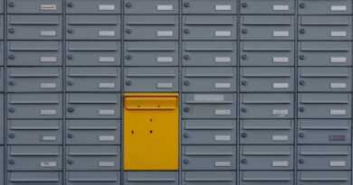 a bunch of mail boxes with a yellow door