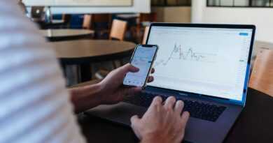 person using smartphone and MacBook Pro