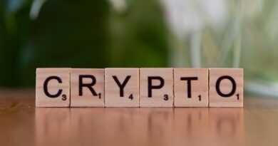 A wooden block spelling crypt on a table