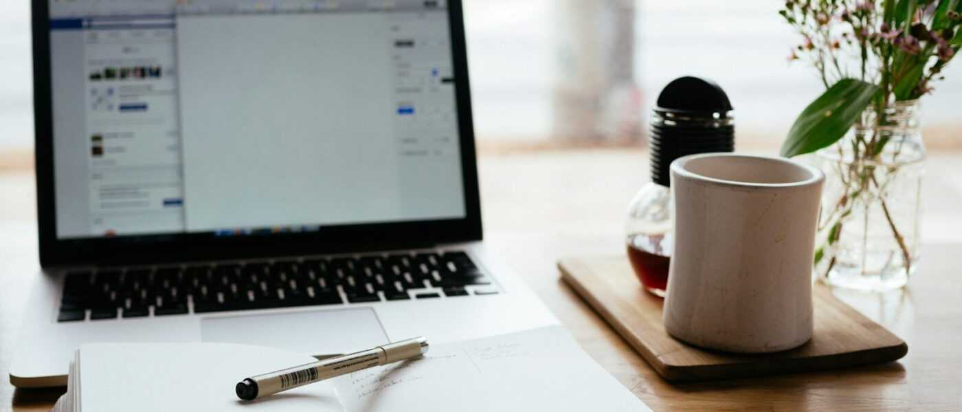 MacBook Pro near white open book